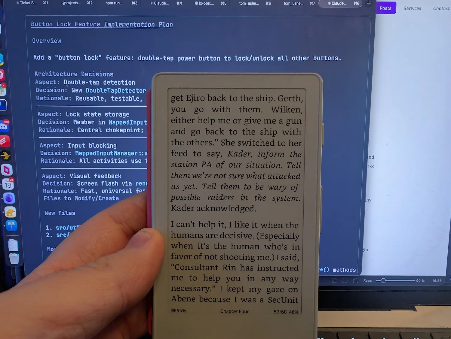 Hand holding an Xteink X4 reader in front of a laptop screen showing Claude Code